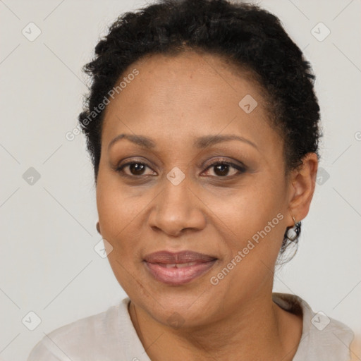 Joyful latino adult female with short  brown hair and brown eyes