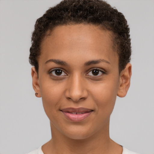 Joyful black young-adult female with short  brown hair and brown eyes