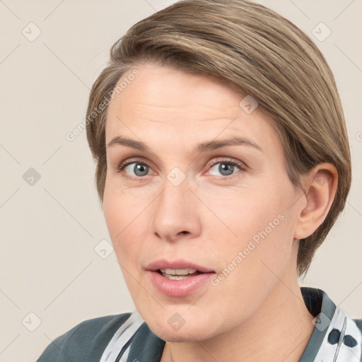 Joyful white adult female with medium  brown hair and grey eyes