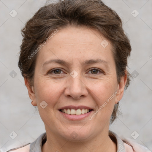 Joyful white adult female with short  brown hair and brown eyes