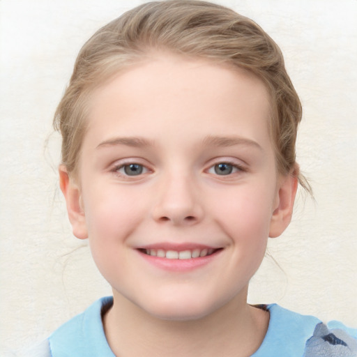 Joyful white child female with short  brown hair and blue eyes