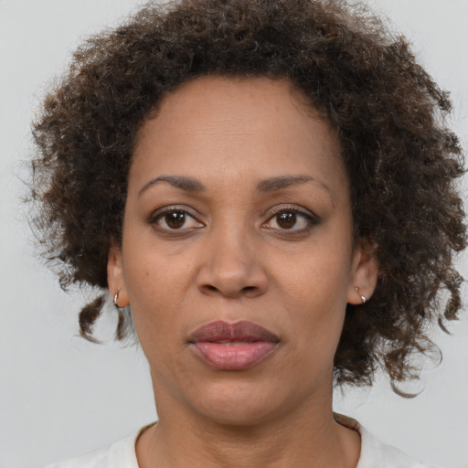 Joyful black adult female with short  brown hair and brown eyes