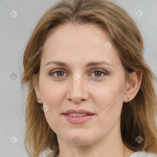 Joyful white young-adult female with medium  brown hair and green eyes