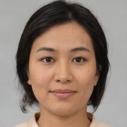 Joyful asian young-adult female with medium  brown hair and brown eyes