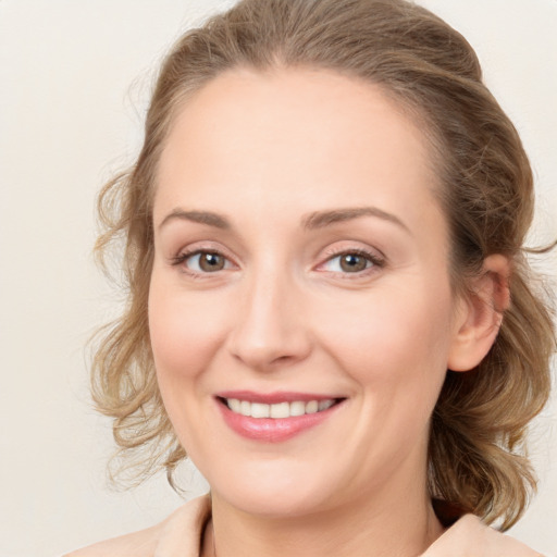 Joyful white young-adult female with medium  brown hair and blue eyes