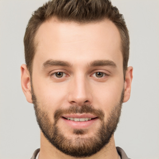 Joyful white young-adult male with short  brown hair and brown eyes