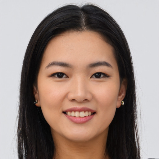 Joyful asian young-adult female with long  brown hair and brown eyes