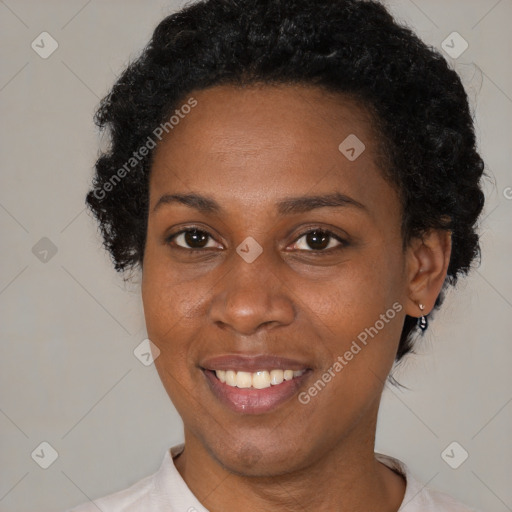 Joyful black adult female with short  brown hair and brown eyes