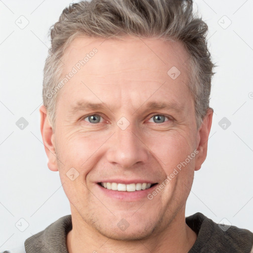 Joyful white adult male with short  brown hair and grey eyes