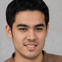 Joyful latino young-adult male with short  brown hair and brown eyes