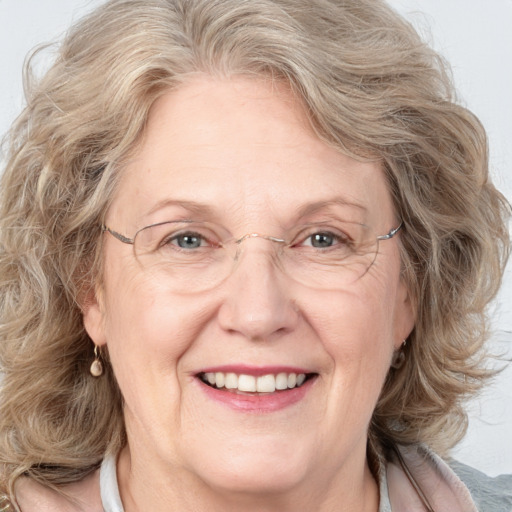 Joyful white middle-aged female with medium  brown hair and blue eyes