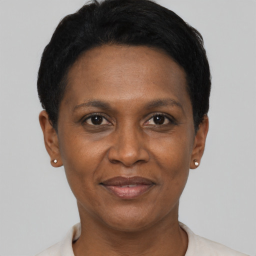 Joyful black adult female with short  black hair and brown eyes