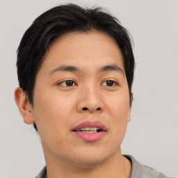 Joyful asian young-adult male with short  brown hair and brown eyes