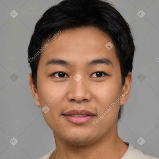 Joyful asian young-adult male with short  black hair and brown eyes