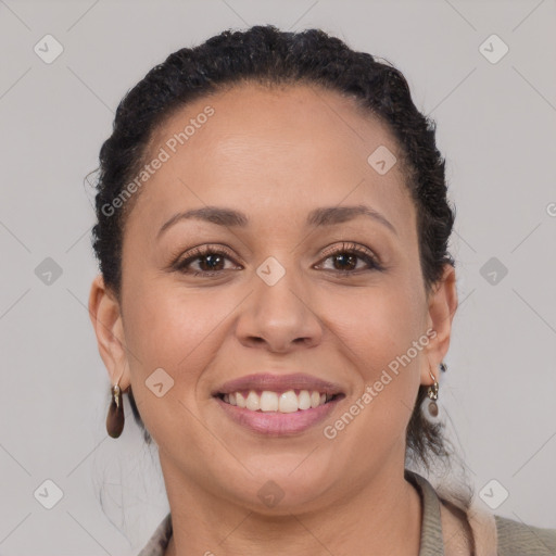 Joyful black adult female with short  brown hair and brown eyes