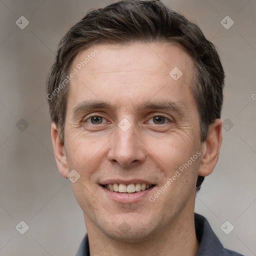 Joyful white adult male with short  brown hair and grey eyes