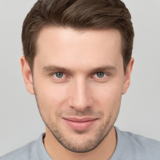 Joyful white young-adult male with short  brown hair and brown eyes