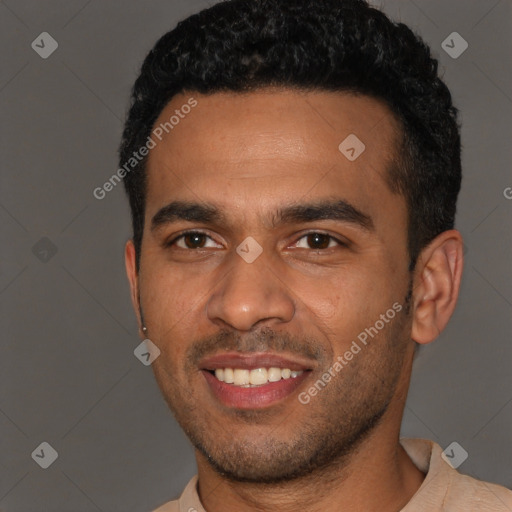 Joyful black young-adult male with short  brown hair and brown eyes