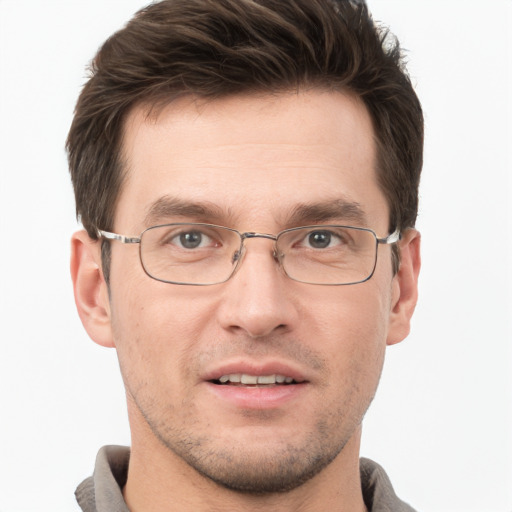 Joyful white adult male with short  brown hair and grey eyes