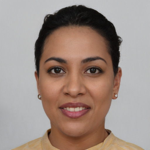 Joyful latino young-adult female with short  black hair and brown eyes