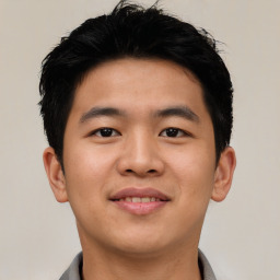 Joyful asian young-adult male with short  black hair and brown eyes