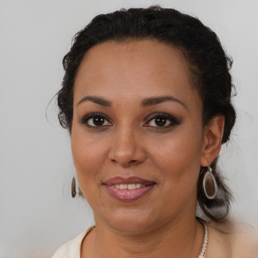 Joyful black young-adult female with medium  brown hair and brown eyes