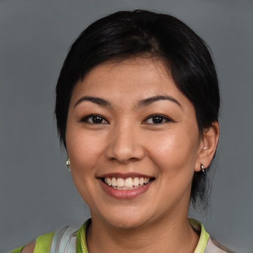 Joyful latino young-adult female with medium  brown hair and brown eyes