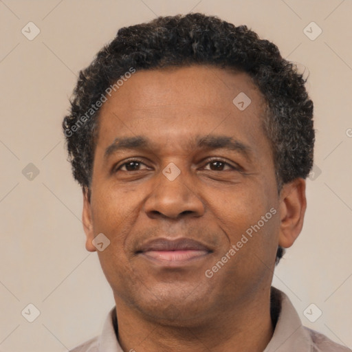 Joyful black adult male with short  black hair and brown eyes