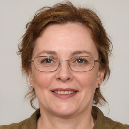 Joyful white middle-aged female with medium  brown hair and blue eyes