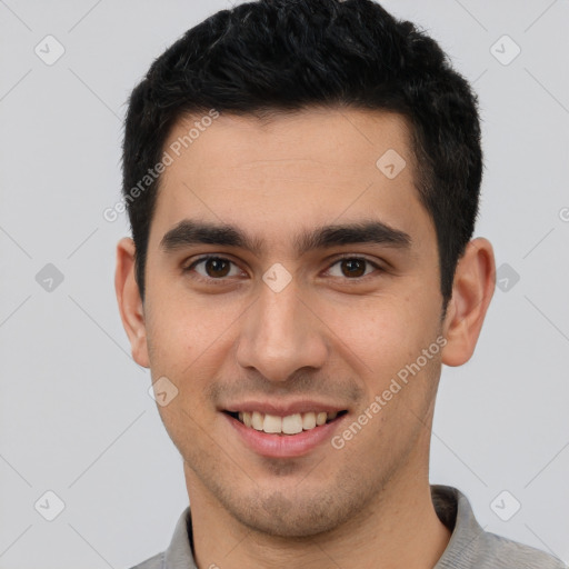 Joyful latino young-adult male with short  brown hair and brown eyes