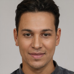 Joyful white adult male with short  brown hair and brown eyes