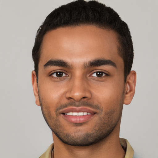 Joyful latino young-adult male with short  brown hair and brown eyes