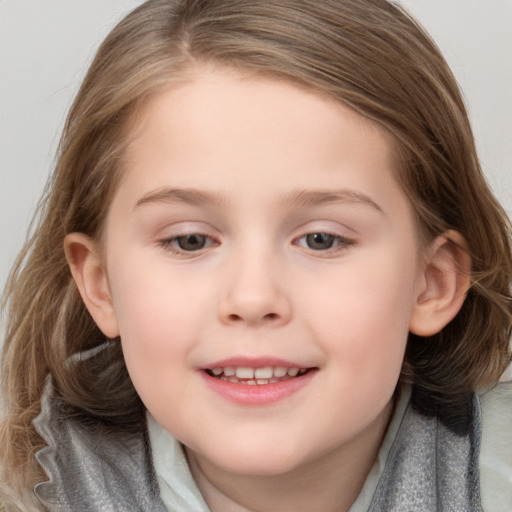 Joyful white child female with medium  brown hair and grey eyes