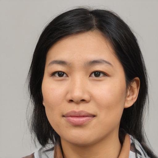 Joyful asian young-adult female with medium  brown hair and brown eyes