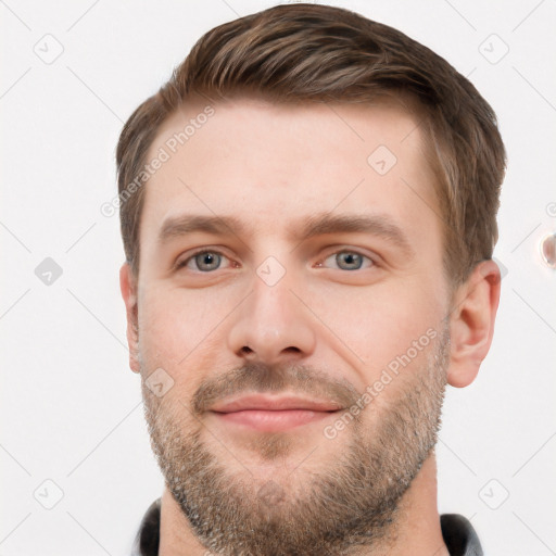 Joyful white young-adult male with short  brown hair and grey eyes