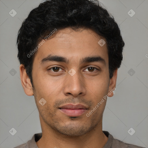 Joyful latino young-adult male with short  brown hair and brown eyes