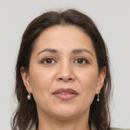 Joyful white adult female with long  brown hair and grey eyes