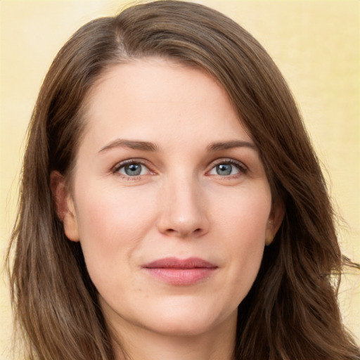 Joyful white young-adult female with long  brown hair and green eyes