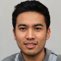 Joyful asian young-adult male with short  black hair and brown eyes