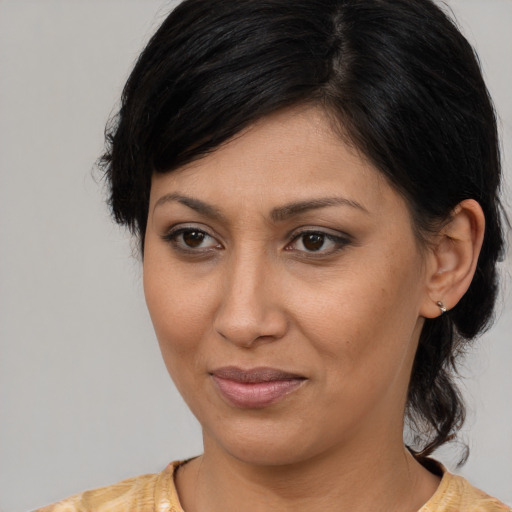 Joyful asian young-adult female with medium  brown hair and brown eyes