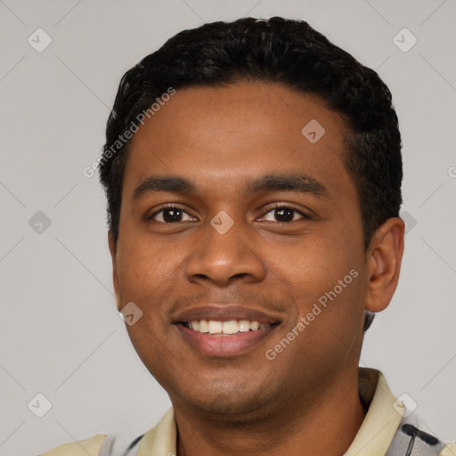 Joyful black young-adult male with short  black hair and brown eyes