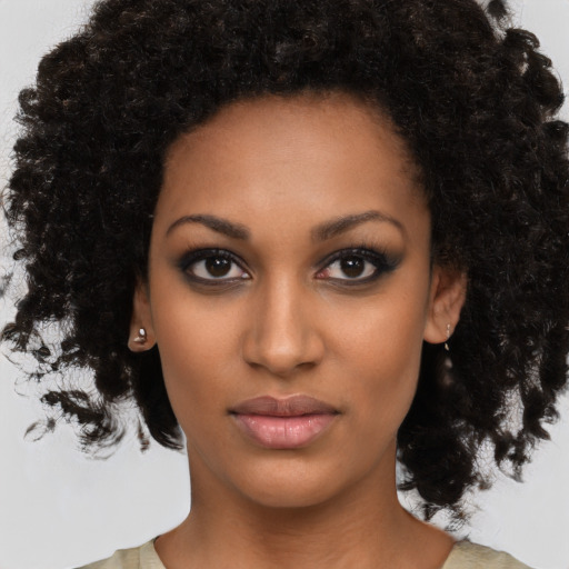 Neutral black young-adult female with medium  brown hair and brown eyes