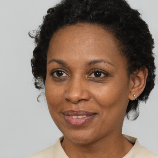 Joyful black adult female with short  brown hair and brown eyes