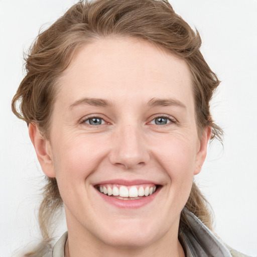 Joyful white young-adult female with medium  brown hair and blue eyes