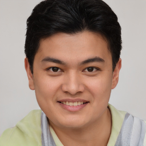 Joyful asian young-adult male with short  brown hair and brown eyes