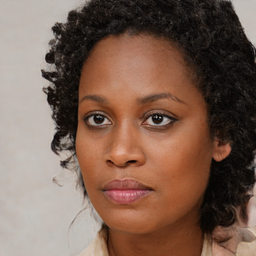 Neutral black young-adult female with medium  brown hair and brown eyes