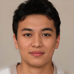 Joyful latino young-adult male with short  brown hair and brown eyes