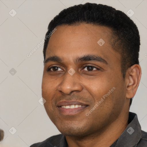 Joyful black young-adult male with short  black hair and brown eyes