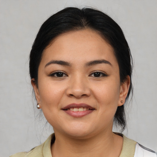 Joyful latino young-adult female with medium  black hair and brown eyes