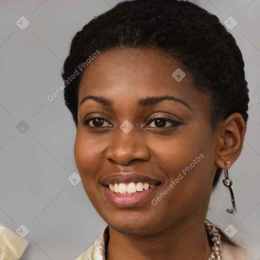 Joyful black young-adult female with short  black hair and brown eyes